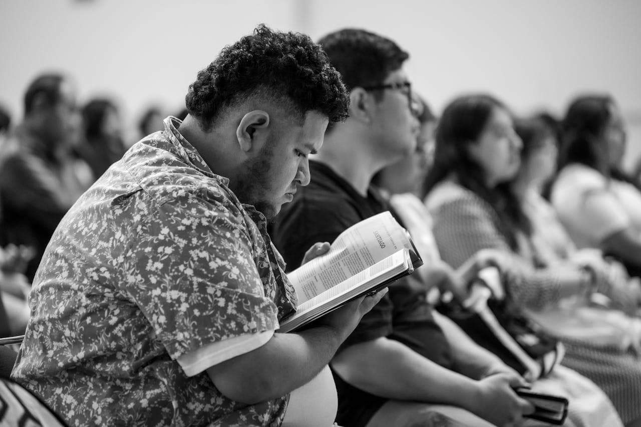A member in quiet reflection with scripture